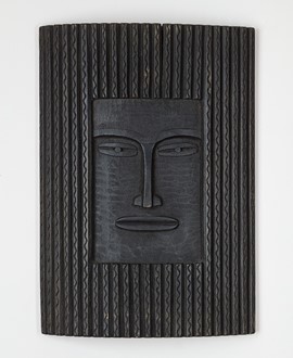 image of a carving in wood representing a mask