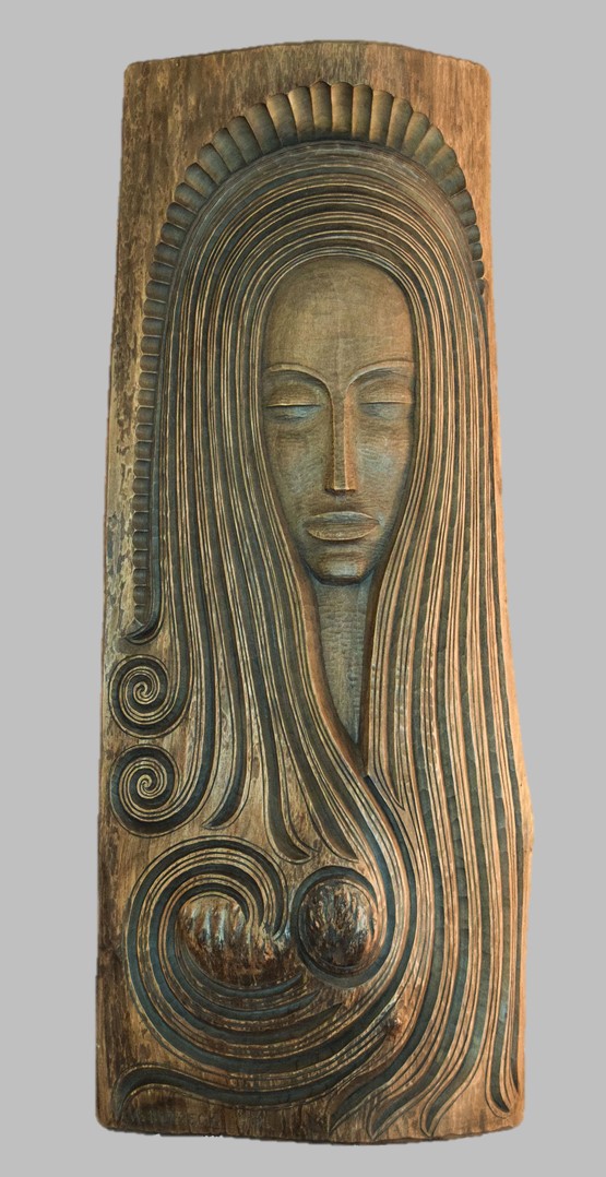 image of a carving in wood presenting a girl with long hair