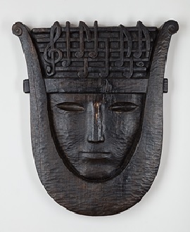 image of a carving in wood representing a lyre
