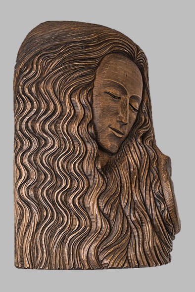 image of a carving in wood representing a young woman