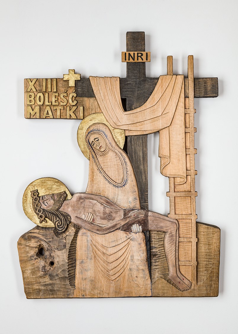 image of a bas relief carved in wood presenting Jesus being taken down from the cross