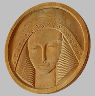 Bas-relief of a woman's head carved in wood entitled Sun Goddess